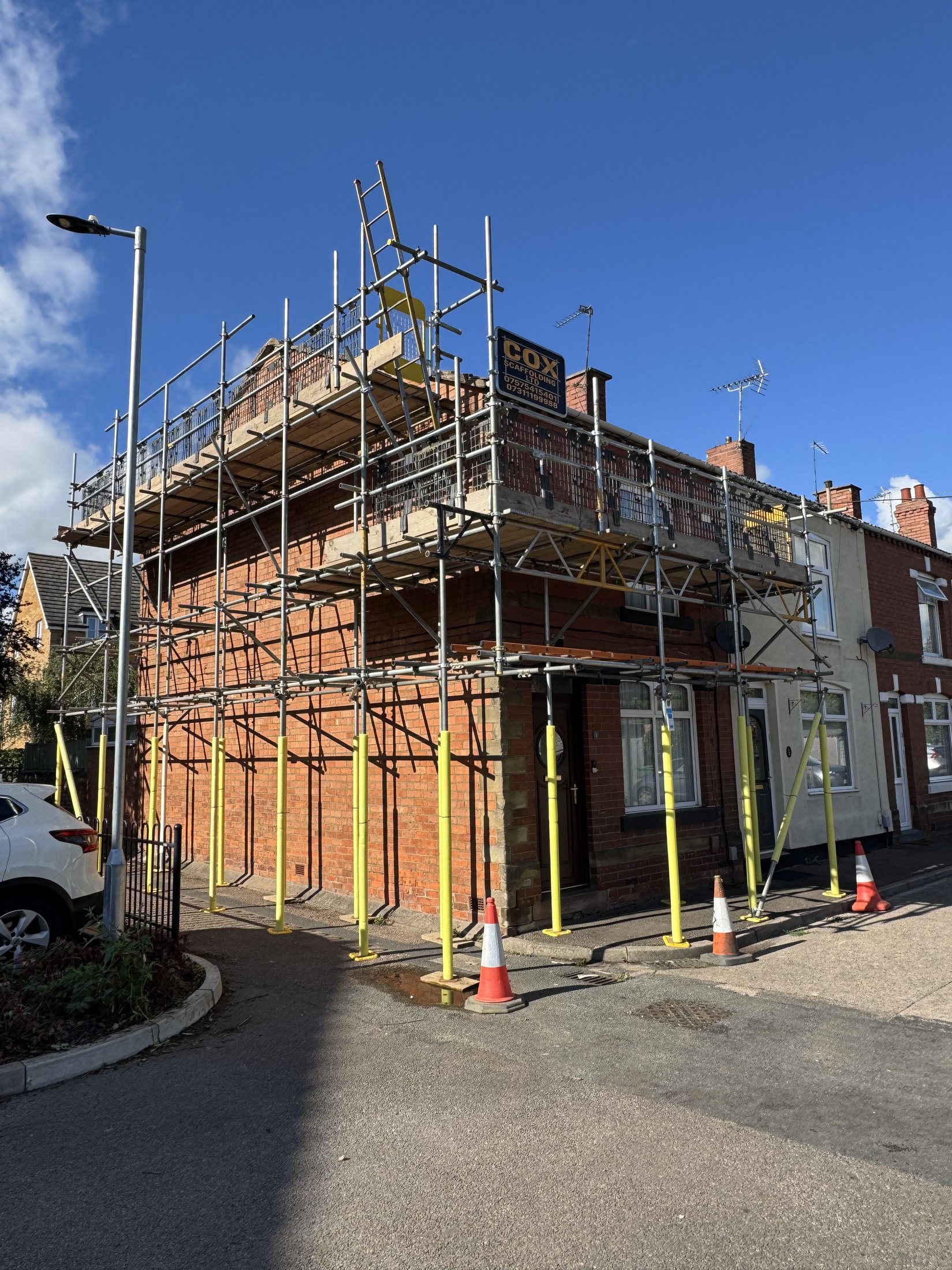 Cox Scaffolding branded scaffold on a residential street